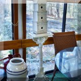 D44. Decorative birdhouse on stand.